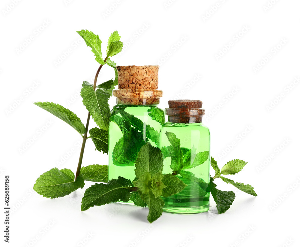 Bottles of essential oil and fresh mint isolated on white background