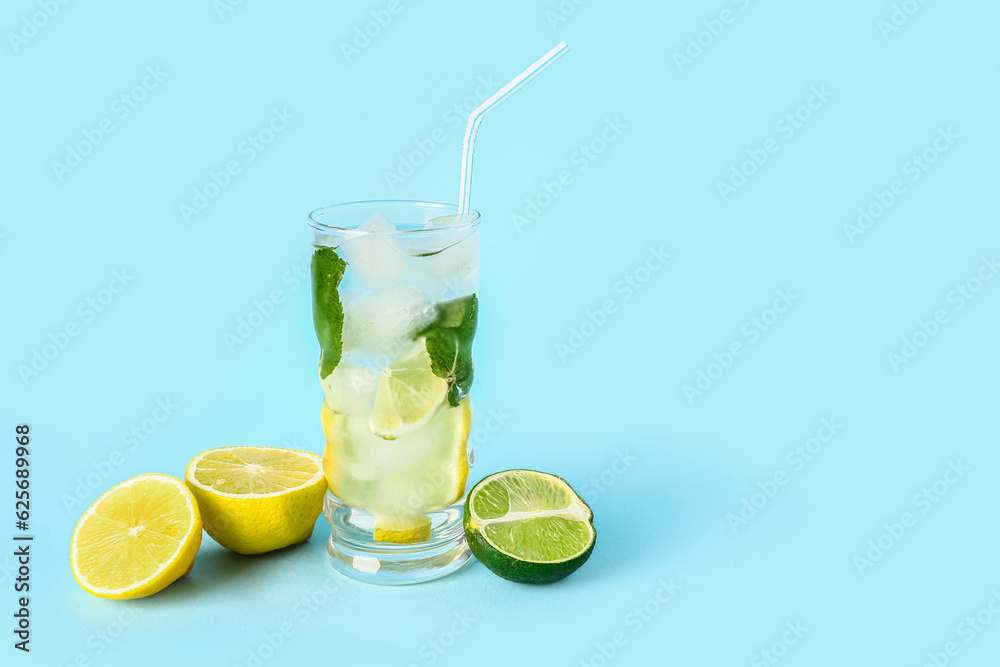 Glass of fresh mojito and citrus fruits on color background