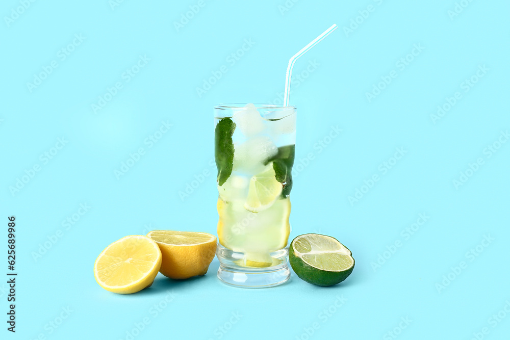 Glass of fresh mojito and citrus fruits on color background