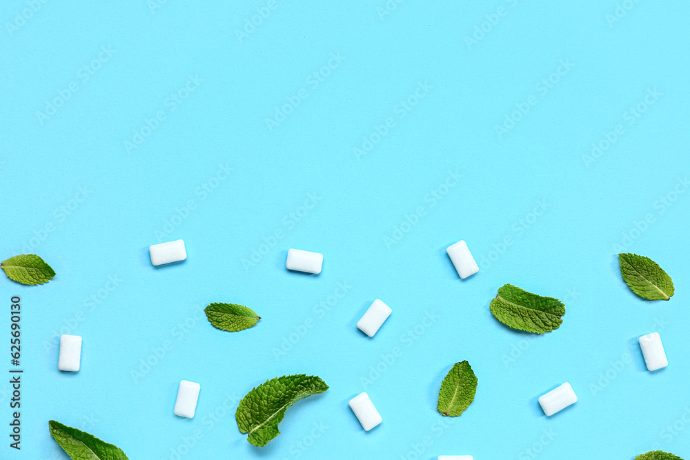 Fresh chewing gums with mint on blue background