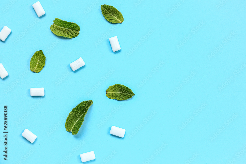 Fresh chewing gums with mint on blue background