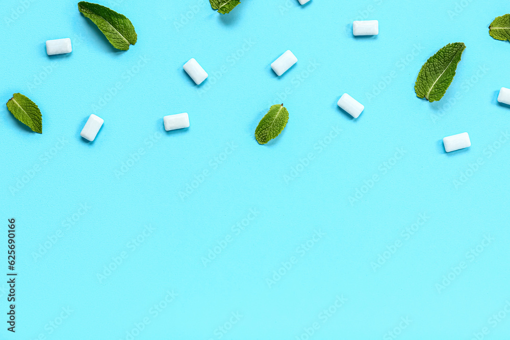 Fresh chewing gums with mint on blue background