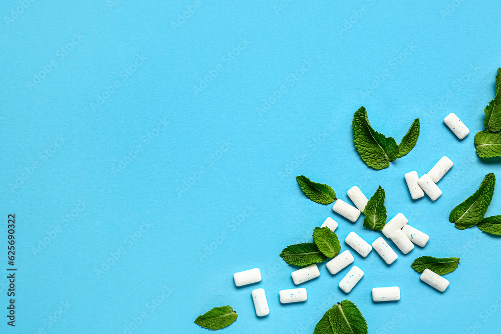 Fresh chewing gums with mint on blue background