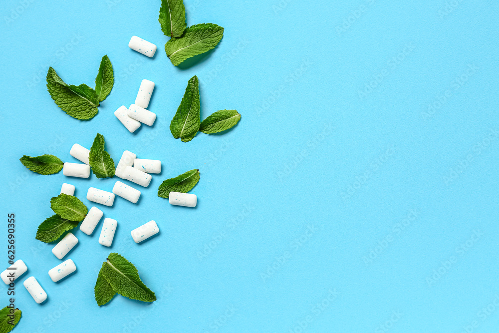 Fresh chewing gums with mint on blue background