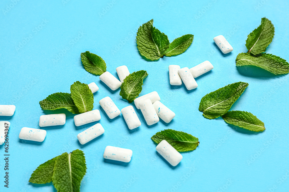 Fresh chewing gums with mint on blue background