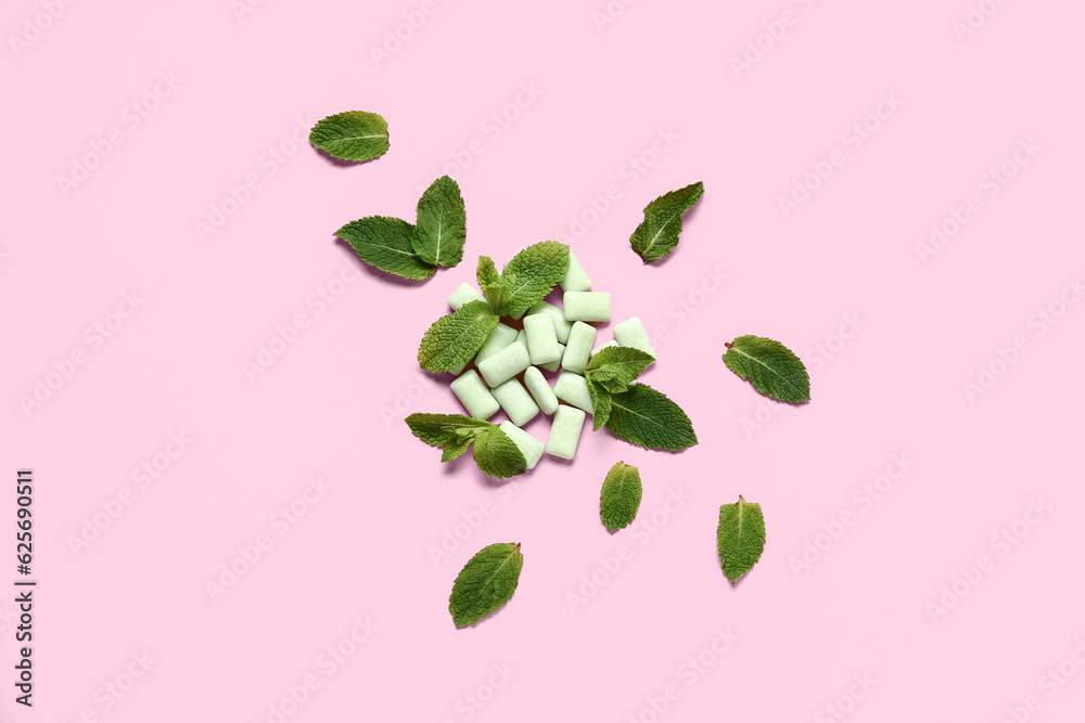 Fresh chewing gums with mint on pink background