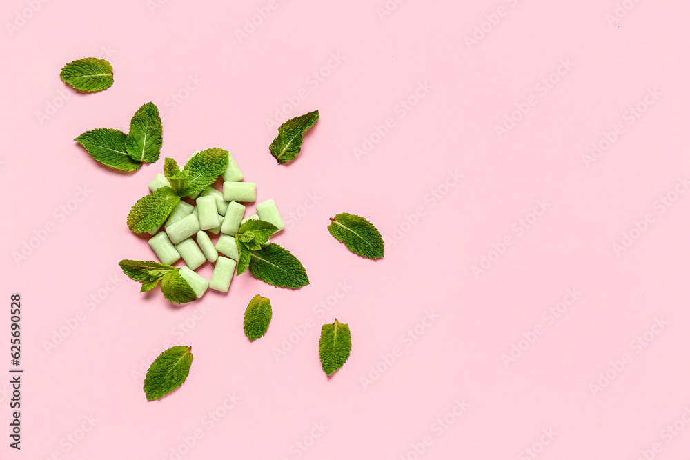 Fresh chewing gums with mint on pink background