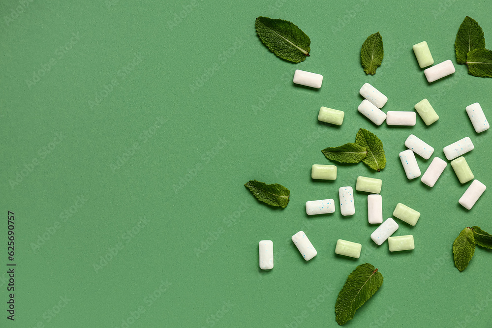 Fresh chewing gums with mint on green background