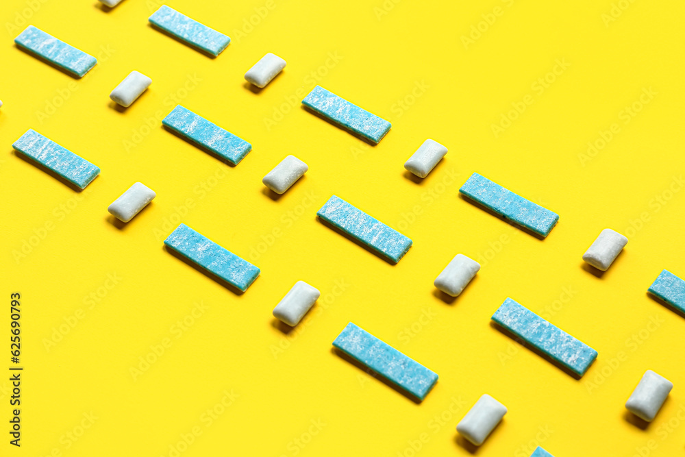 Fresh chewing gums on yellow background