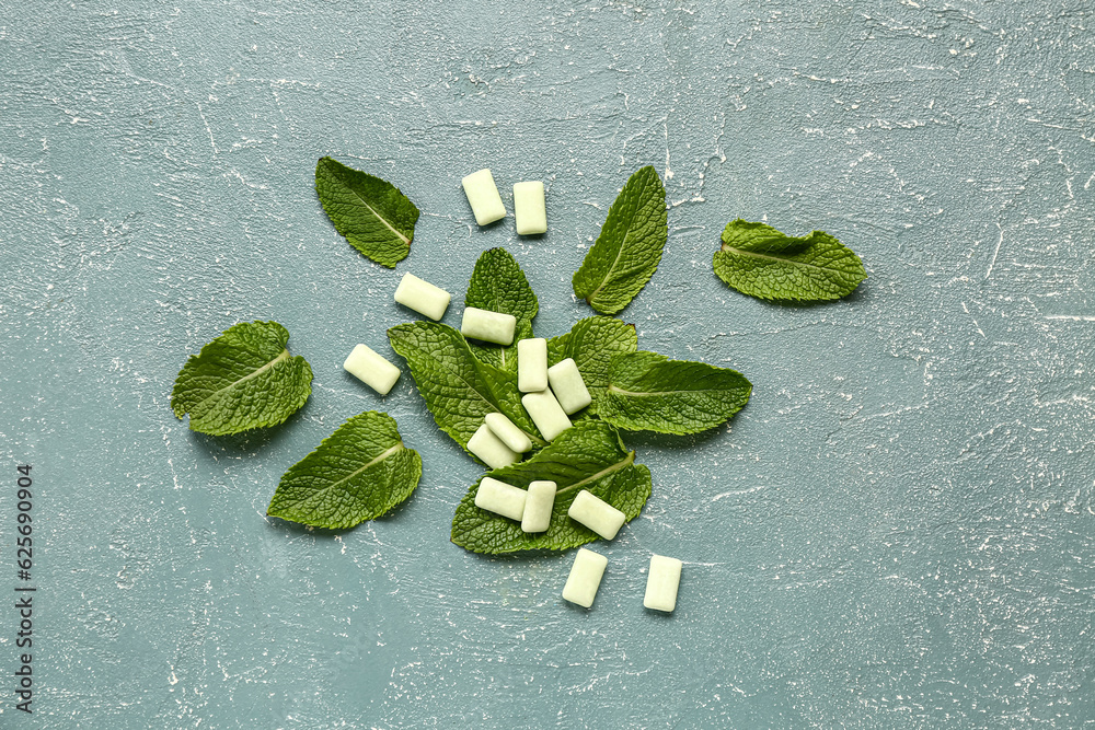 Fresh chewing gums with mint on blue background