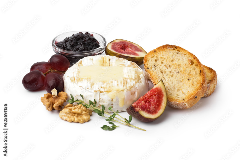 Tasty baked Camembert cheese with bread, jam, figs and grapes on white background