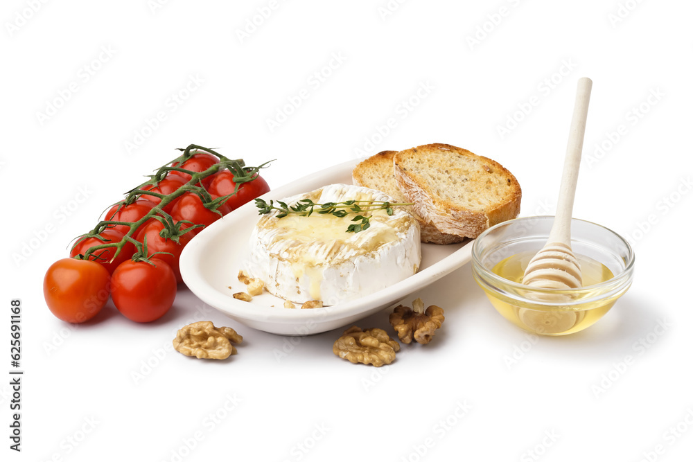 Plate of tasty baked Camembert cheese with tomatoes, honey and bread on white background