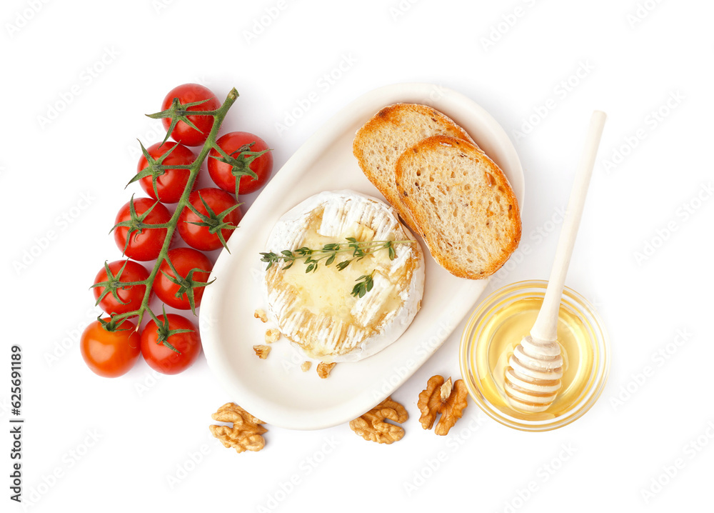 Plate of tasty baked Camembert cheese with tomatoes, honey and bread on white background