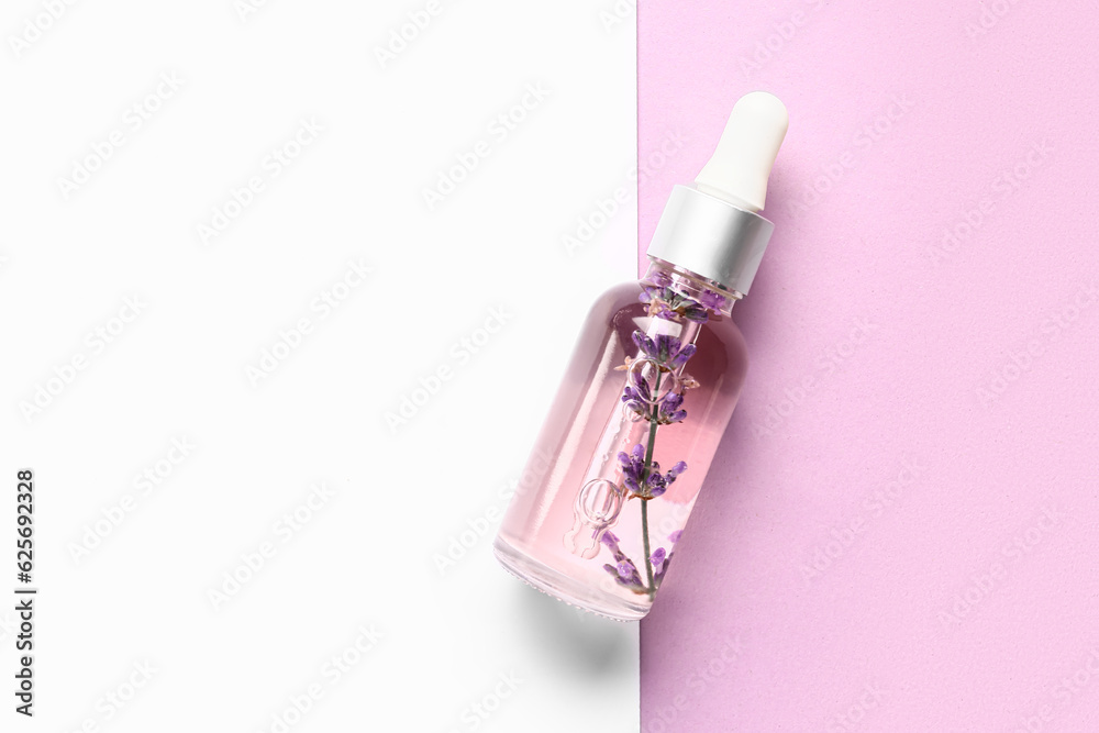 Bottle of lavender essential oil on color background