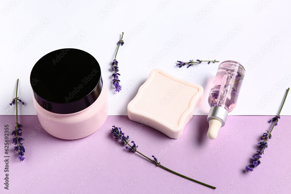 Set of cosmetic products and lavender flowers on color background