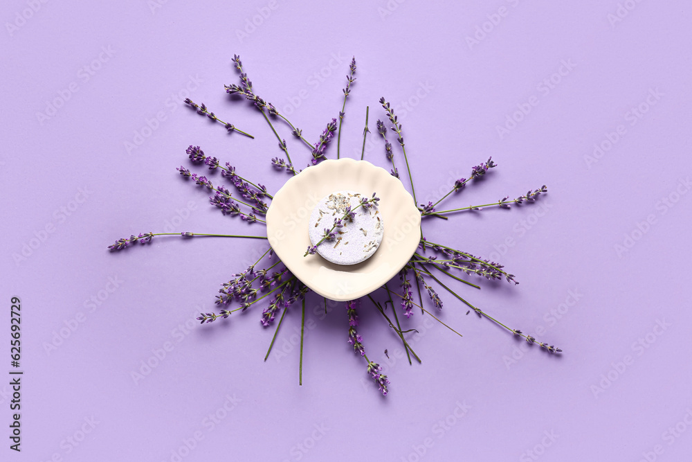 Composition with soap bar and aromatic lavender flowers on color background