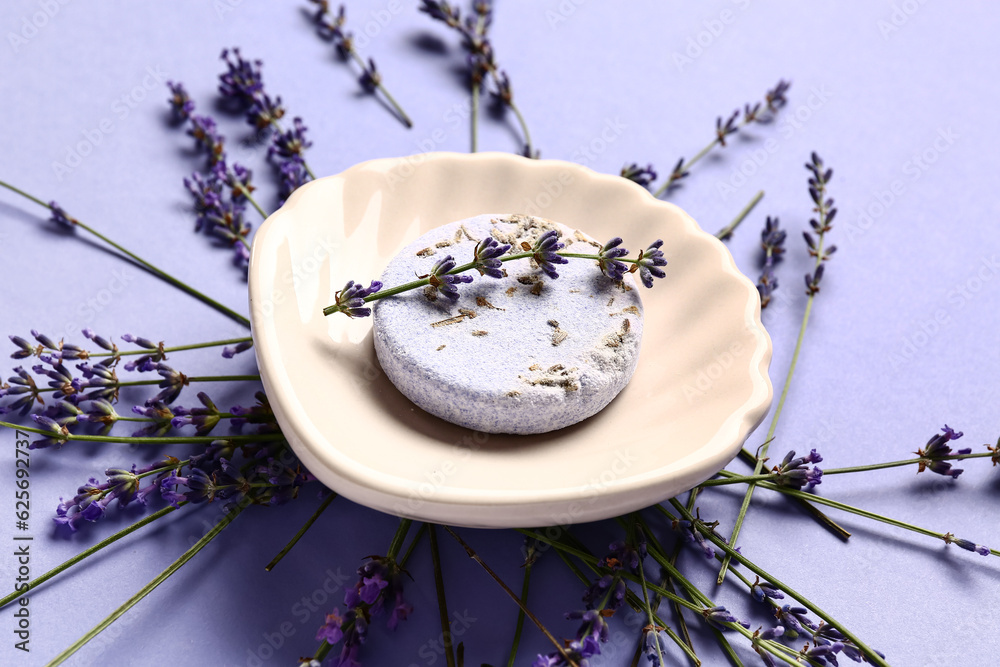 Composition with soap bar and aromatic lavender flowers on color background