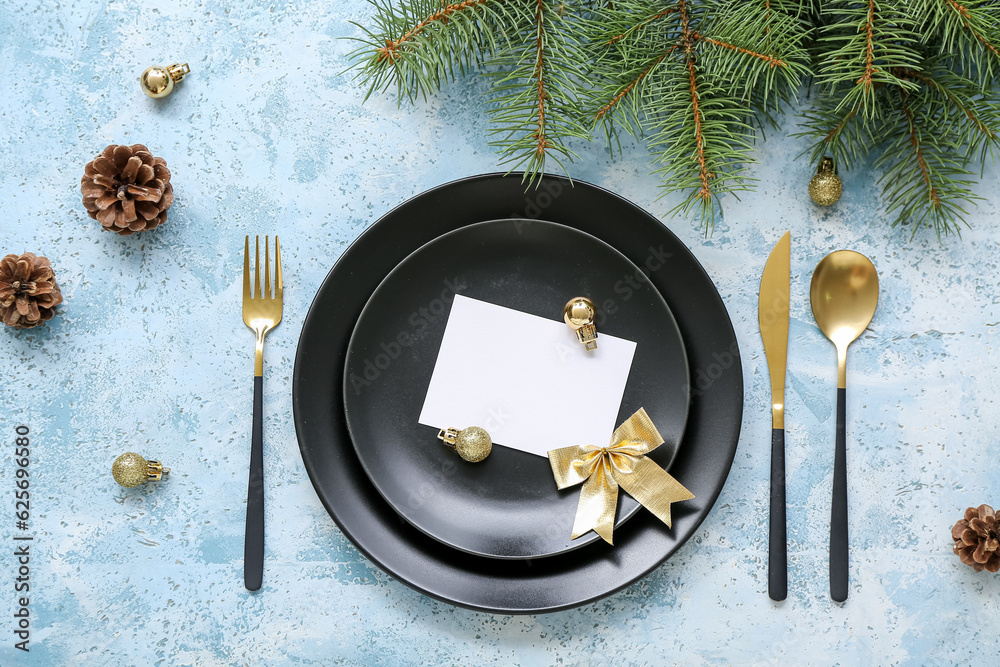 Beautiful table setting for Christmas celebration on blue background