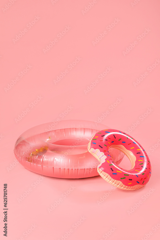 Inflatable rings on pink background