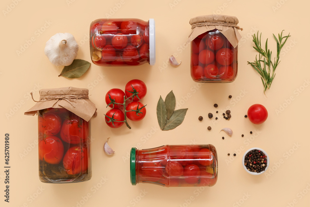 Jars with canned tomatoes, peppercorn and garlic on beige background