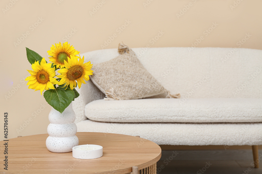 Vase with sunflowers on table in living room