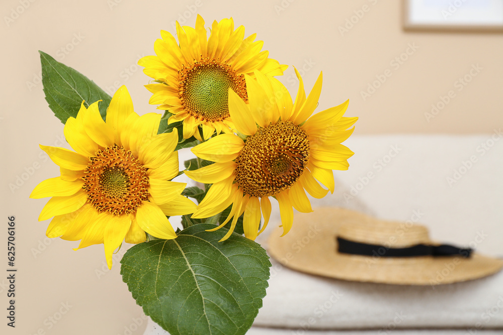 Vase with sunflowers in living room, closeup