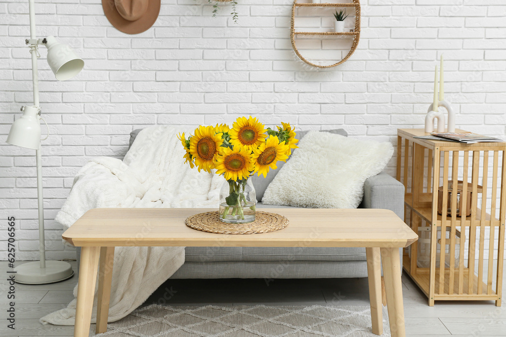 Interior of living room with sunflowers in vase on table