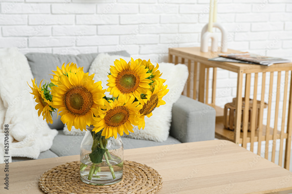 Vase with sunflowers on table in living room, closeup