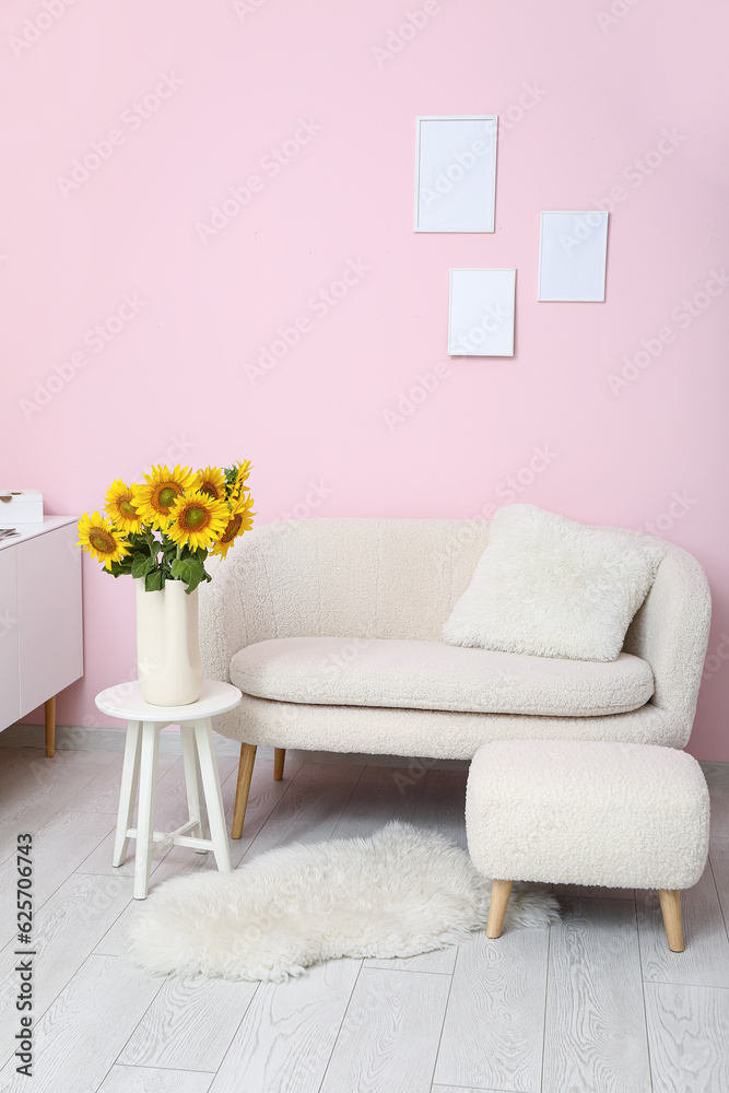 Interior of living room with sunflowers in vase on table