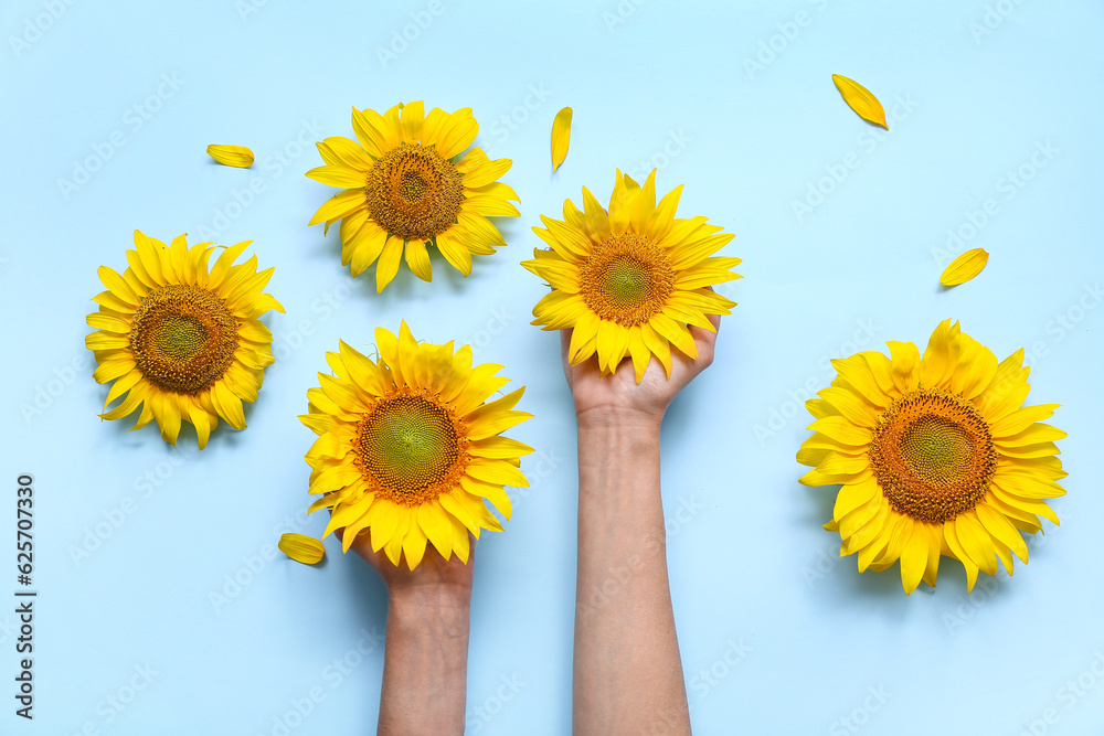 Woman with sunflowers on blue background