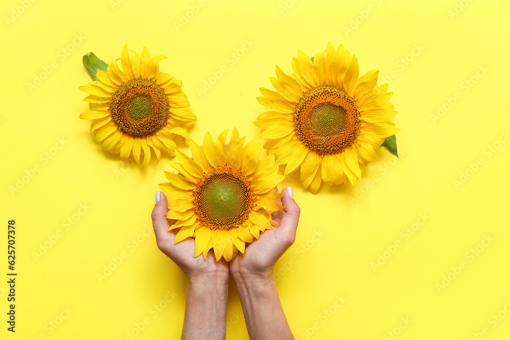 Woman with sunflowers on yellow background