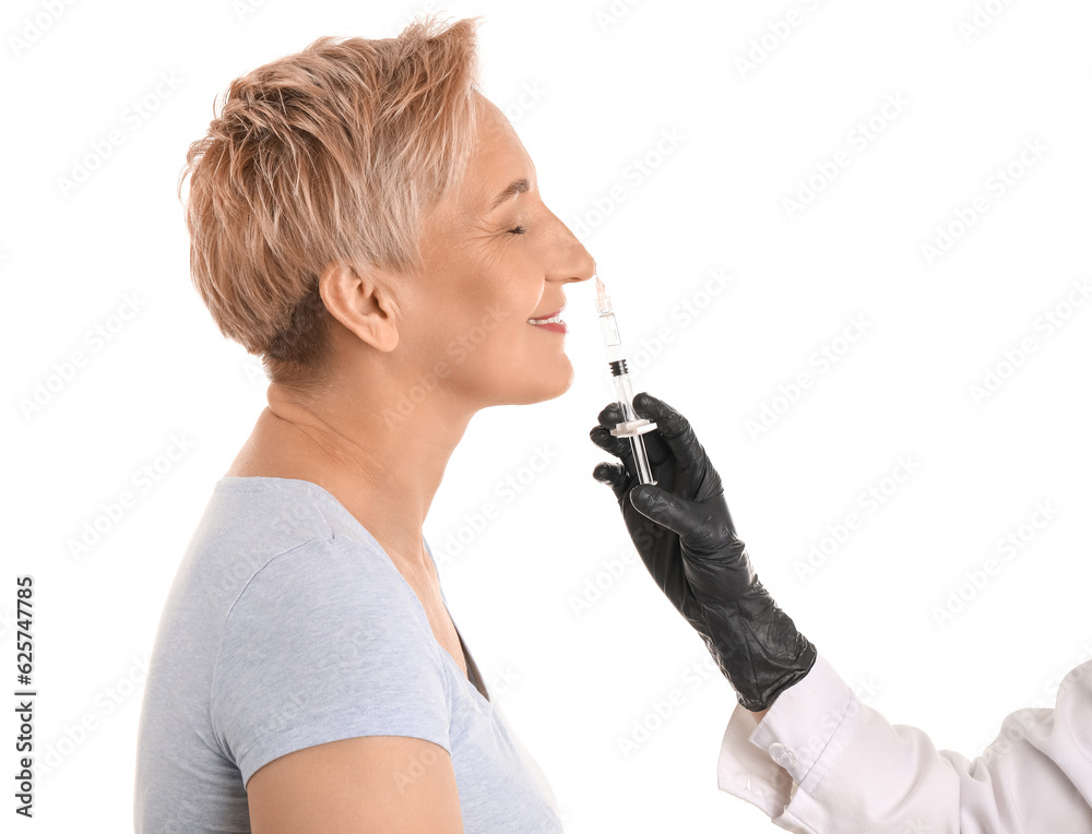 Mature woman receiving filler injection on white background, closeup