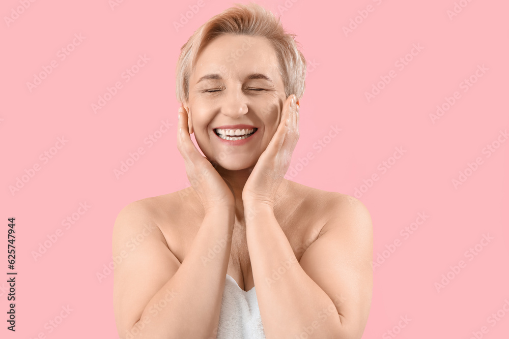 Happy mature woman on pink background, closeup