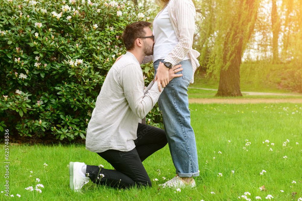 Beautiful happy loving couple in park on spring day