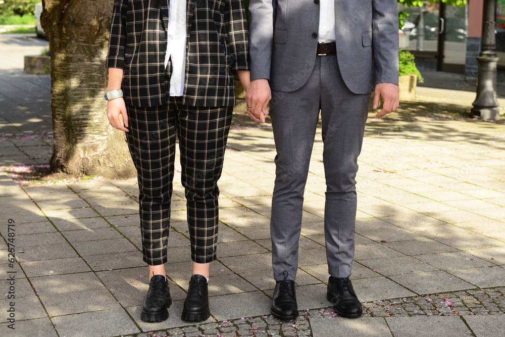 Beautiful loving young couple holding hands on sunny spring day