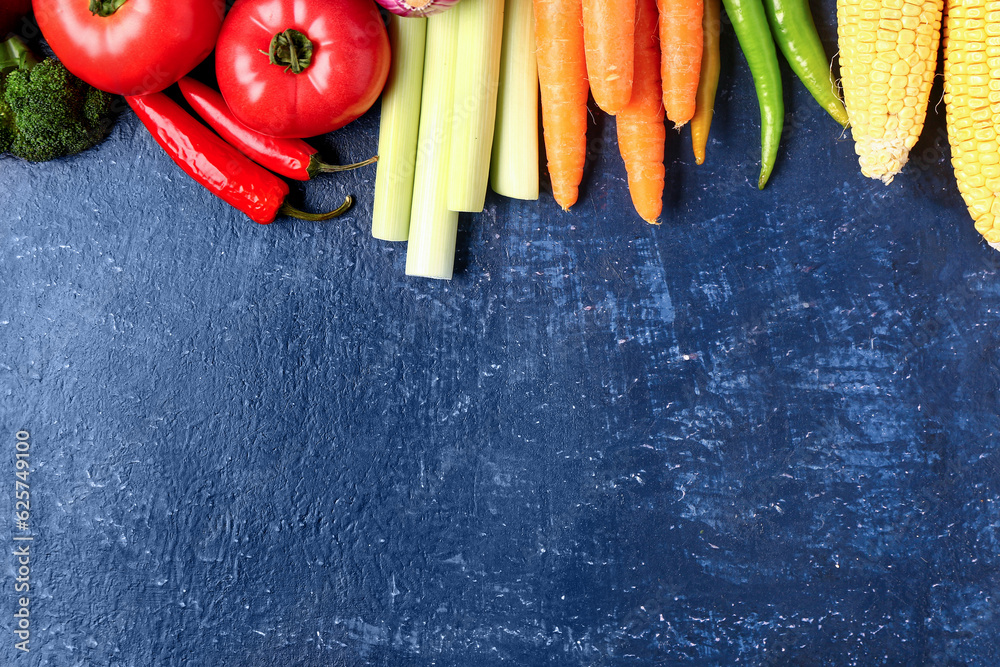 Different fresh vegetables on blue background