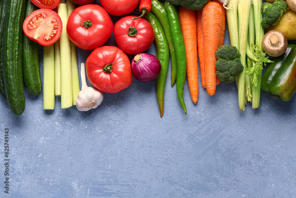 Different fresh vegetables on blue background