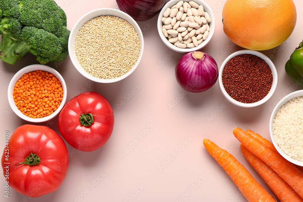 Different fresh vegetables and cereals on pink background