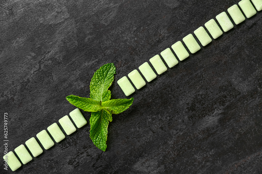 Fresh chewing gums with mint on black background