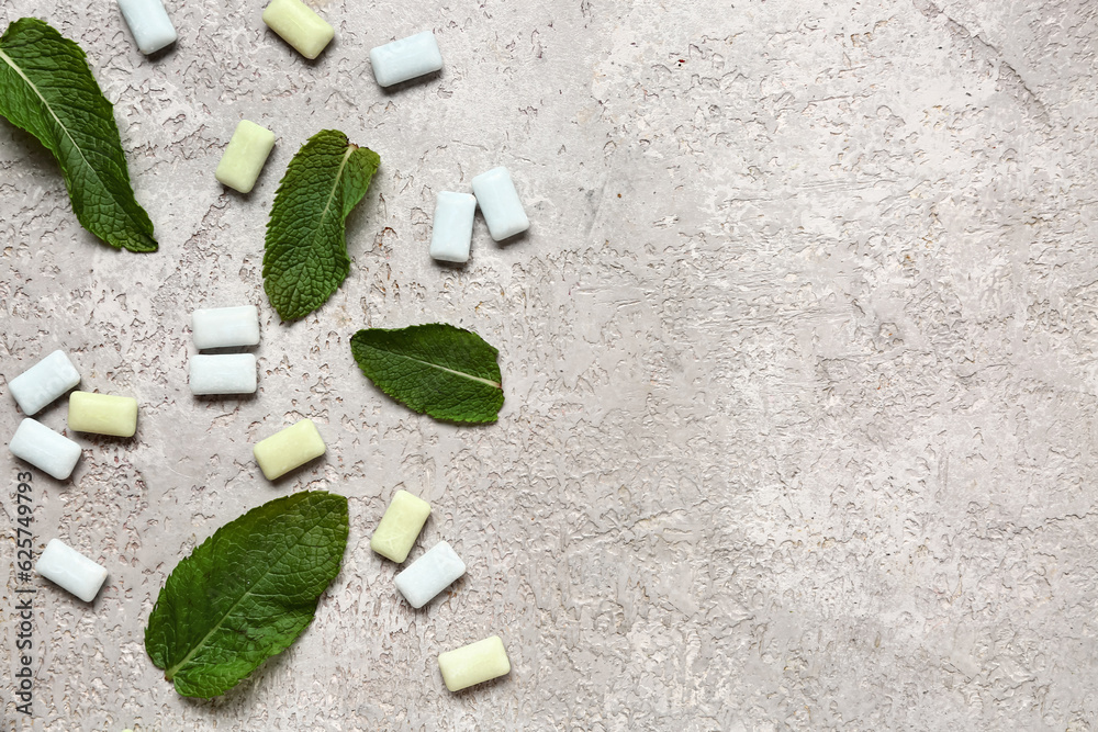 Fresh chewing gums with mint on grey background