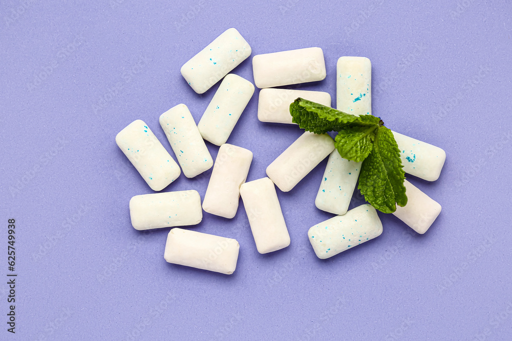 Fresh chewing gums with mint on lilac background