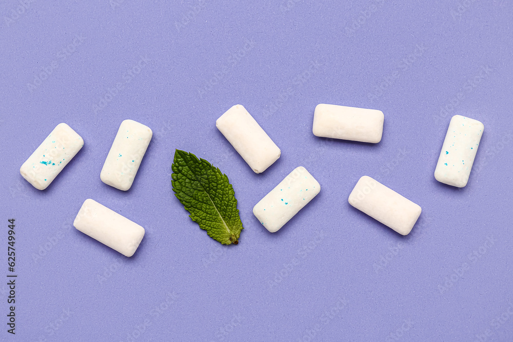 Fresh chewing gums with mint on lilac background