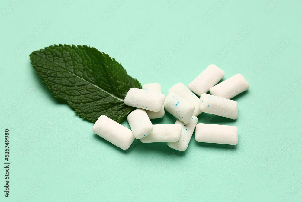 Fresh chewing gums with mint on turquoise background