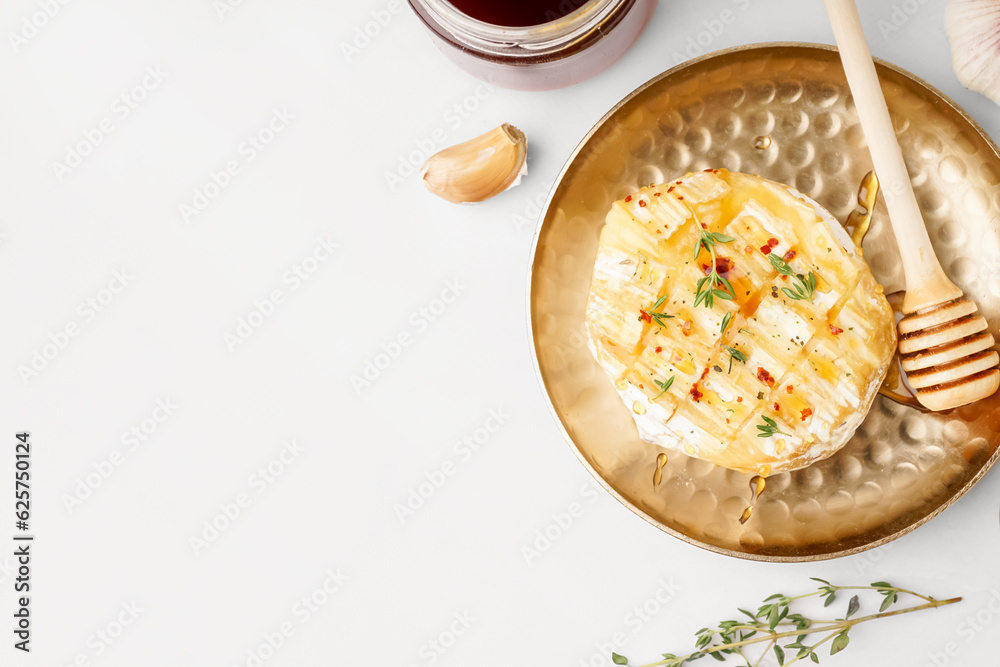 Plate with tasty baked Camembert cheese on grey background