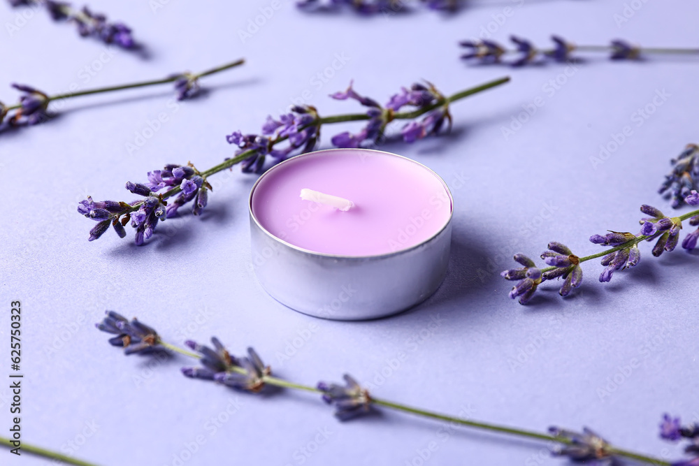 Composition with candle and lavender flowers on color background