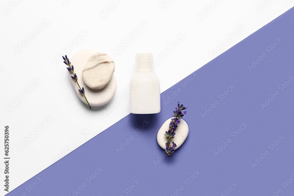 Composition with bottle of cosmetic product, spa stones and lavender flowers on color background