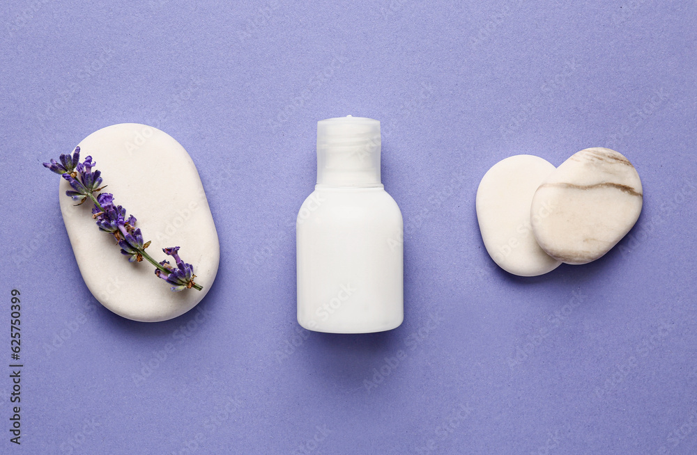 Composition with bottle of cosmetic product, spa stones and lavender flower on color background