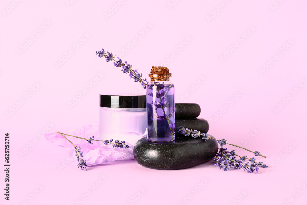 Composition with cosmetic products, spa stones and lavender flowers on lilac background