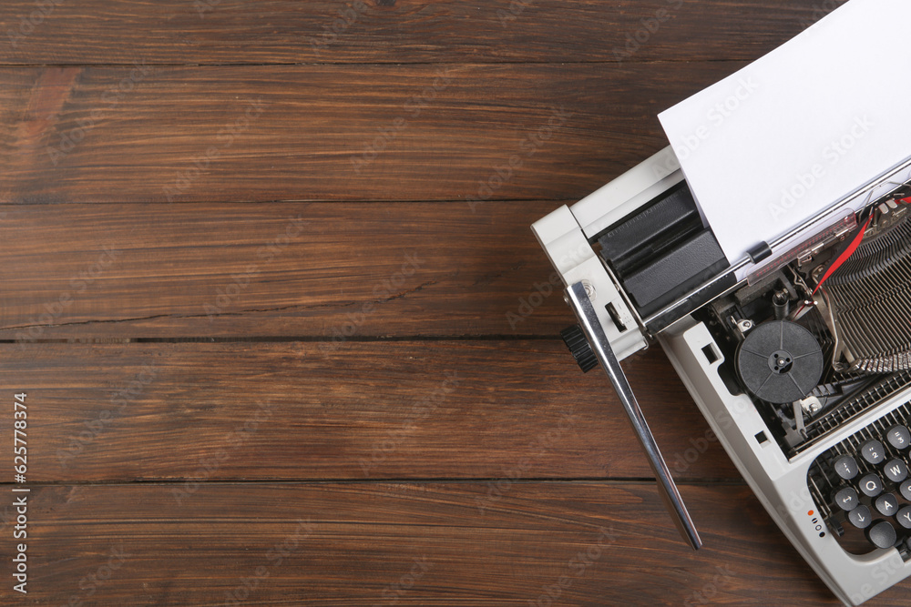 vintage typewriter on the table with blank paper on wooden desk - concept for writing, journalism, b