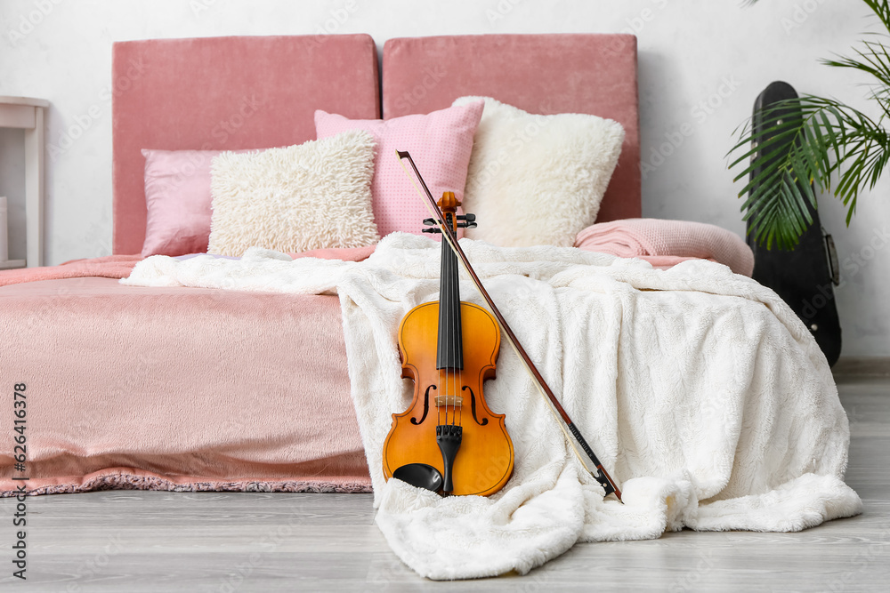 Interior of modern bedroom with violin